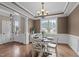 Dining room with wainscoting, decorative chandelier and views to the outside at 1117 Golden Star Way, Wake Forest, NC 27587