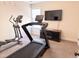 Brightly lit exercise room with treadmill, elliptical machine and modern finishes at 1117 Golden Star Way, Wake Forest, NC 27587