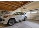 Clean garage showcasing a white SUV parked inside with a bicycle hanging on the wall at 1117 Golden Star Way, Wake Forest, NC 27587