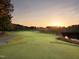 Scenic view of the golf course at sunset with a lake nearby at 1117 Golden Star Way, Wake Forest, NC 27587