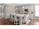 Stylish kitchen with white cabinets, quartz countertops, pendant lighting, and hardwood floors at 1117 Golden Star Way, Wake Forest, NC 27587