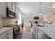 Kitchen island features quartz countertops and a sink with views into the living area at 1117 Golden Star Way, Wake Forest, NC 27587