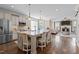 Open kitchen featuring a large island with seating, stainless steel appliances, and hardwood floors at 1117 Golden Star Way, Wake Forest, NC 27587