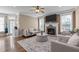 Cozy living room featuring a fireplace, ceiling fan, and neutral-toned furniture at 1117 Golden Star Way, Wake Forest, NC 27587
