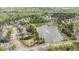 Aerial view of neighborhood pond with dock, fountain, playground and wooded surroundings at 1117 Golden Star Way, Wake Forest, NC 27587