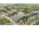 Aerial view of the community pond with fountain, dock, and surrounding homes and trees at 1117 Golden Star Way, Wake Forest, NC 27587