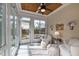 Bright sunroom with views of the backyard, a ceiling fan, and comfortable seating at 1117 Golden Star Way, Wake Forest, NC 27587