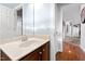 Bathroom featuring a single sink vanity with marble countertop and view of hallway at 1122 Virginia Water Dr, Rolesville, NC 27571