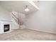 Spacious living room with a fireplace, staircase, and neutral carpet at 1213 Red Beech Ct, Raleigh, NC 27614