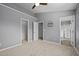 Neutral bedroom featuring a ceiling fan and two entryways to the bathroom and closet at 1217 Maroon Dr, Durham, NC 27713