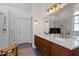 Bright bathroom featuring double sinks with a marble countertop and a glass shower at 1419 Norton St, Durham, NC 27701