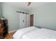 Bedroom with hardwood floors, white walls, and closet and bathroom access at 1419 Norton St, Durham, NC 27701