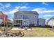 Spacious backyard featuring a patio, fire pit, and lush landscaping at 1421 Sweetclover Dr, Wake Forest, NC 27587