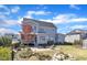 Spacious backyard featuring a patio, fire pit, and lush landscaping, with a view of the home's exterior at 1421 Sweetclover Dr, Wake Forest, NC 27587