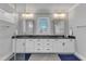 Bright bathroom featuring double vanities with granite countertops and modern fixtures, adjacent to a glass-enclosed shower at 1421 Sweetclover Dr, Wake Forest, NC 27587