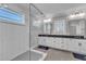Modern bathroom boasting a glass shower, dual vanities, and contemporary finishes for a spa-like experience at 1421 Sweetclover Dr, Wake Forest, NC 27587