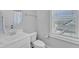 Clean, all-white half bathroom with a modern sink, toilet, and natural light from the window, creating a fresh space at 1421 Sweetclover Dr, Wake Forest, NC 27587