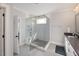 Modern bathroom featuring a glass-enclosed shower with a seat and neutral color palette at 1421 Sweetclover Dr, Wake Forest, NC 27587