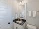 Well-lit bathroom with a framed mirror, granite countertops, and stylish fixtures at 1421 Sweetclover Dr, Wake Forest, NC 27587