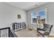 Bedroom features carpet, a rocking chair, and a harlequin changing table at 1421 Sweetclover Dr, Wake Forest, NC 27587