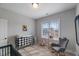 Bedroom featuring a crib, rocking chair, and neutral decor at 1421 Sweetclover Dr, Wake Forest, NC 27587