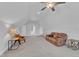 Bright bonus room with a ceiling fan, featuring a comfortable leather couch and tasteful decor for a cozy ambiance at 1421 Sweetclover Dr, Wake Forest, NC 27587