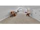 Expansive bonus room showcasing plush furniture and abundant natural light, offering versatile living and entertainment space at 1421 Sweetclover Dr, Wake Forest, NC 27587
