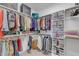 Well-organized walk-in closet featuring custom shelving, hanging rods, and storage solutions for clothes and accessories at 1421 Sweetclover Dr, Wake Forest, NC 27587