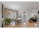 Bright dining area with wainscoting, a modern light fixture and hardwood floors at 1421 Sweetclover Dr, Wake Forest, NC 27587