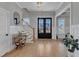 Bright foyer with hardwood floors, staircase, wainscoting, and natural light at 1421 Sweetclover Dr, Wake Forest, NC 27587