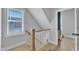 Hallway features stairs with wood railing, hardwood floors, and natural light at 1421 Sweetclover Dr, Wake Forest, NC 27587