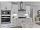 Modern kitchen with white cabinets, stainless steel appliances, and granite countertops at 1421 Sweetclover Dr, Wake Forest, NC 27587