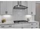 Close up on modern kitchen with white cabinets, stainless steel appliances, and tile backsplash at 1421 Sweetclover Dr, Wake Forest, NC 27587