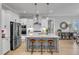 Spacious kitchen features an island with seating, stainless steel appliances, and ample cabinet space at 1421 Sweetclover Dr, Wake Forest, NC 27587