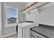 A spacious laundry room with a window and washer and dryer at 1421 Sweetclover Dr, Wake Forest, NC 27587
