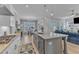 Open floor plan with kitchen island, dining area and living room that includes a blue sofa at 1421 Sweetclover Dr, Wake Forest, NC 27587