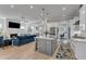 Open concept living space featuring a kitchen island and a living room with a fireplace at 1421 Sweetclover Dr, Wake Forest, NC 27587