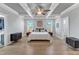 Spacious main bedroom with coffered ceilings, hardwood floors, and a luxurious ensuite bathroom entrance at 1421 Sweetclover Dr, Wake Forest, NC 27587
