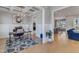 Stylish office features a modern chandelier, coffered ceilings, and a chic patterned rug on the light-colored hardwood floors at 1421 Sweetclover Dr, Wake Forest, NC 27587