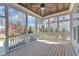 Relaxing screened porch featuring a wood ceiling, ceiling fan, and views of the landscaped backyard at 1421 Sweetclover Dr, Wake Forest, NC 27587