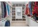 Well-organized walk-in closet featuring shelving, hanging space, and a window for natural light at 1421 Sweetclover Dr, Wake Forest, NC 27587