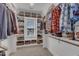 Organized walk-in closet with custom shelving, maximizing storage and showcasing an extensive wardrobe at 1421 Sweetclover Dr, Wake Forest, NC 27587
