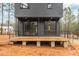 A modern home features a wooden deck with sleek black railings and easy access to the backyard at 168 Daphine Dr, Hillsborough, NC 27278