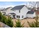 Backyard view of a two-story home with a covered patio, a fenced yard and mature trees at 176 E Ravano Dr, Clayton, NC 27527
