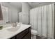 Neutral toned bathroom featuring a patterned shower curtain and dark wood vanity at 176 E Ravano Dr, Clayton, NC 27527