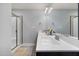 Bright bathroom with double sinks, a large mirror, and a glass-enclosed shower at 176 E Ravano Dr, Clayton, NC 27527