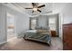 Bedroom with a bed and ceiling fan and a view into the adjoining bathroom at 176 E Ravano Dr, Clayton, NC 27527