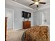 Bedroom featuring a bed, a dresser, TV and access to the bathroom at 176 E Ravano Dr, Clayton, NC 27527