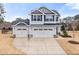 Charming two-story home featuring a two car garage, landscaped yard, and neutral colored siding at 176 E Ravano Dr, Clayton, NC 27527