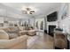 Bright living room with a fireplace, ceiling fan, hardwood floors, and ample natural light at 176 E Ravano Dr, Clayton, NC 27527